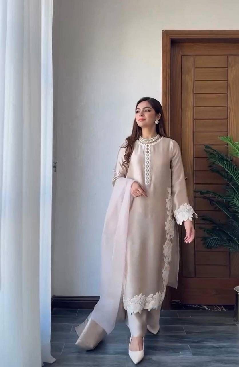 Woman wearing Champagne Beige embroidered natural silk palazzo suit with matching dupatta