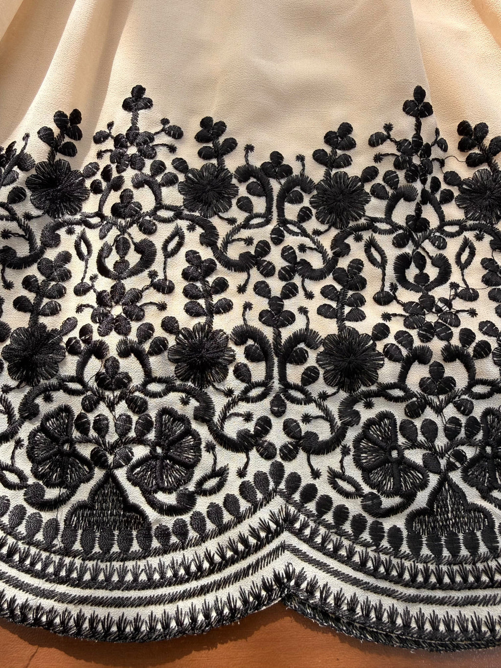 Close-up of black thread embroidery border on Champagne Beige Faux Georgette suit