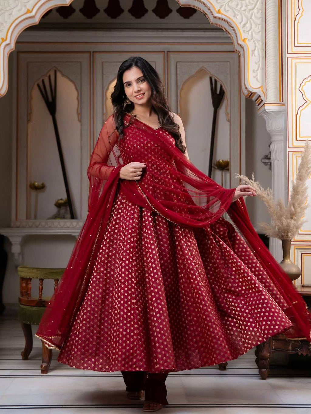 Model showcasing flare of maroon Chanderi Jacquard Anarkali Set