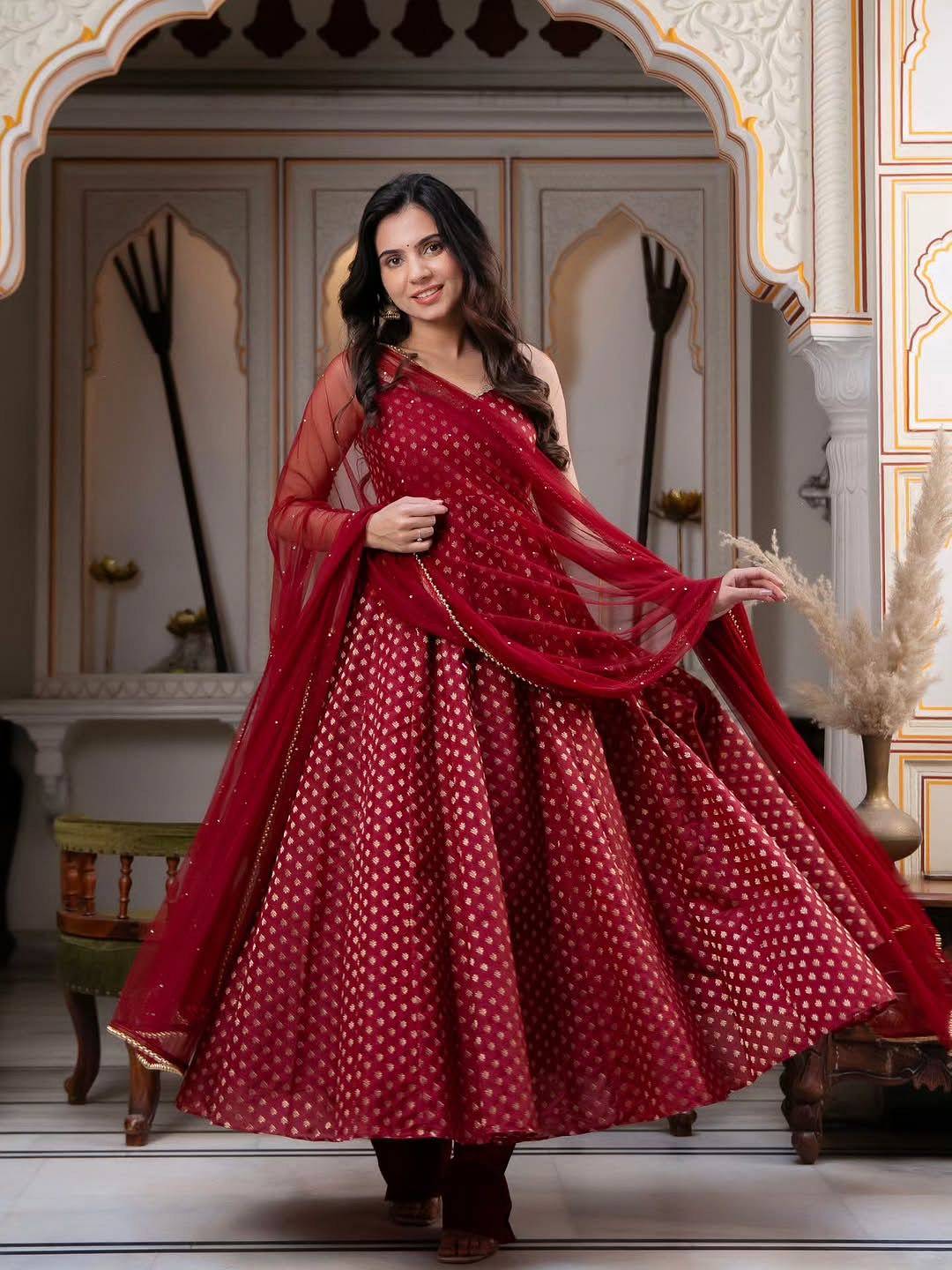 Model showcasing flare of maroon Chanderi Jacquard Anarkali Set