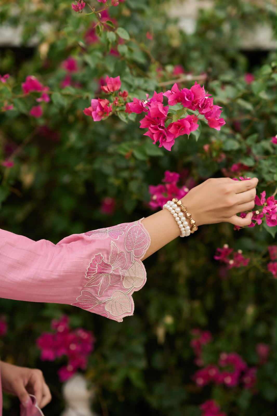 Close-up portrait of Dusty Rose embroidered satin kurta with floral sequence embroidery