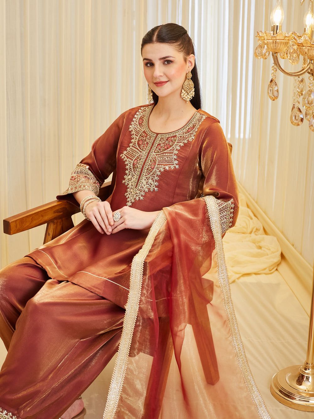 Designer farshi salwar suit set seated pose showcasing embroidery work
