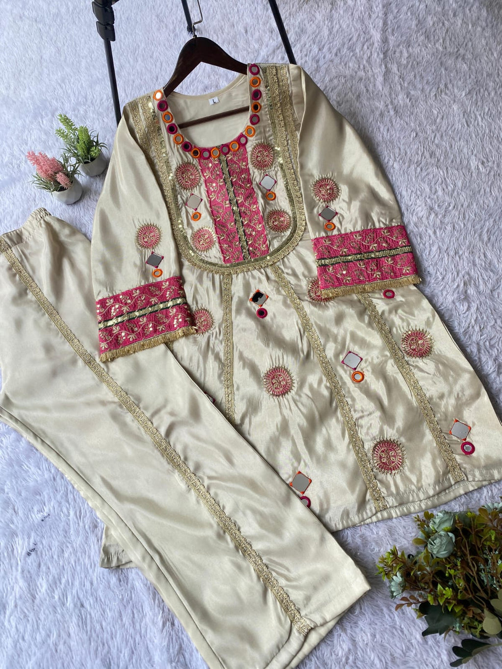 Flat lay of Ivory Cream Cos Moss mirror and sequence embroidered co-ord set with palazzo