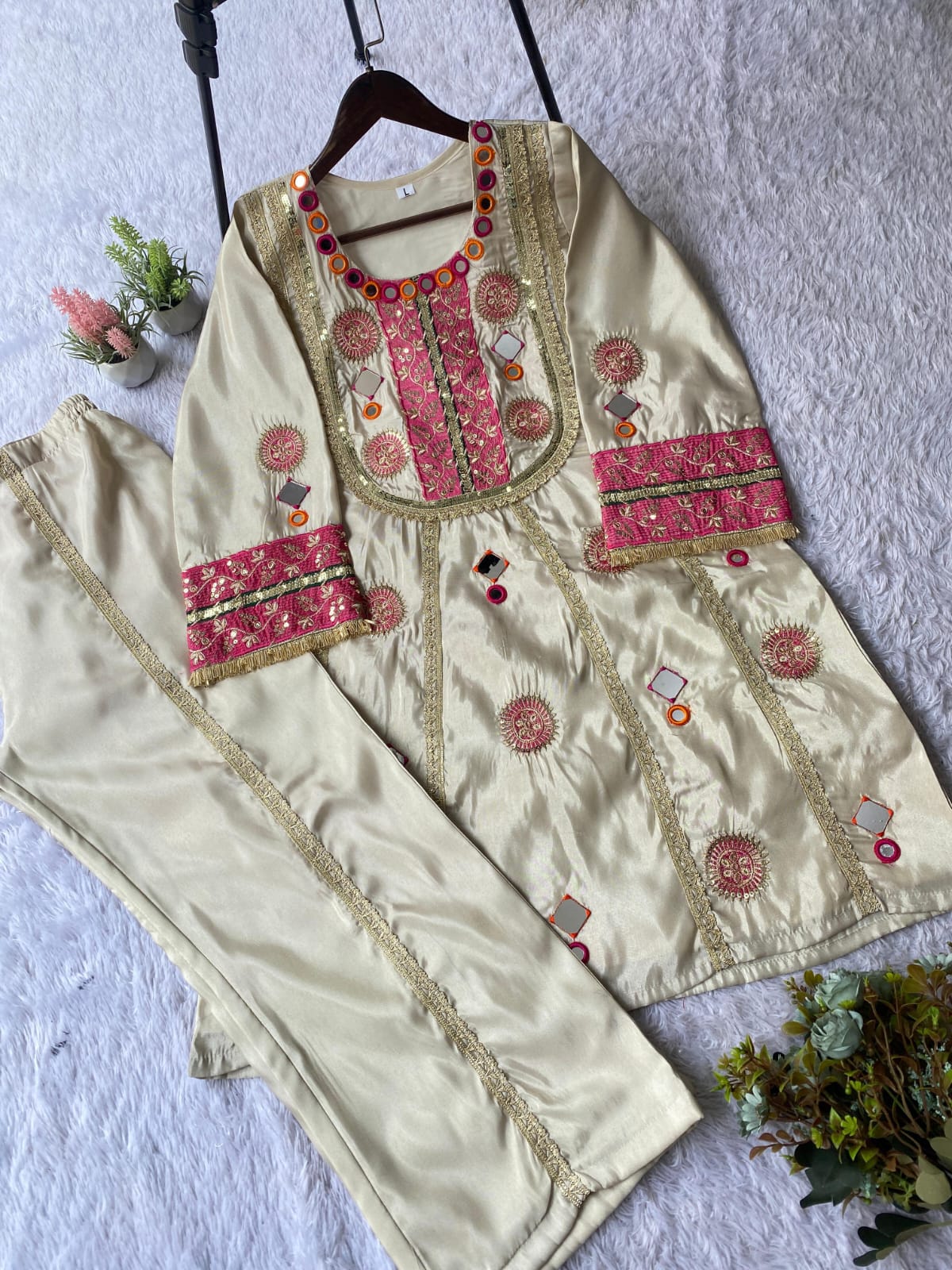 Flat lay of Ivory Cream Cos Moss mirror and sequence embroidered co-ord set with palazzo
