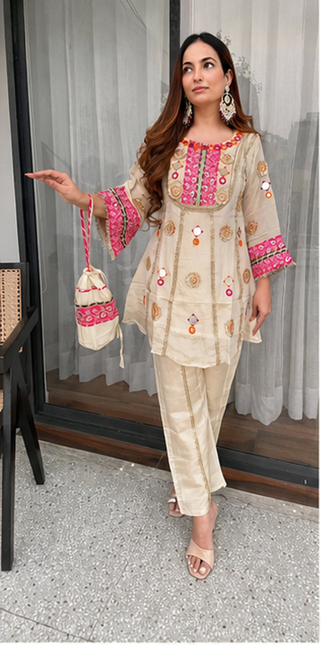 Woman wearing Ivory Cream Cos Moss mirror and sequence embroidered co-ord set with matching palazzo front view