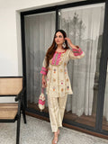 Lifestyle portrait of woman wearing Ivory Cream mirror and sequence embroidered co-ord set