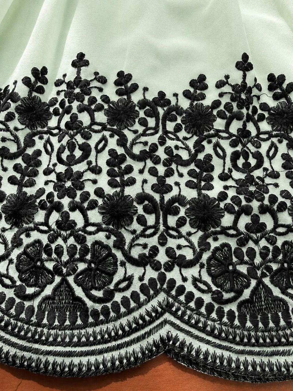 Close-up of black thread embroidery border on Mint Green Faux Georgette suit