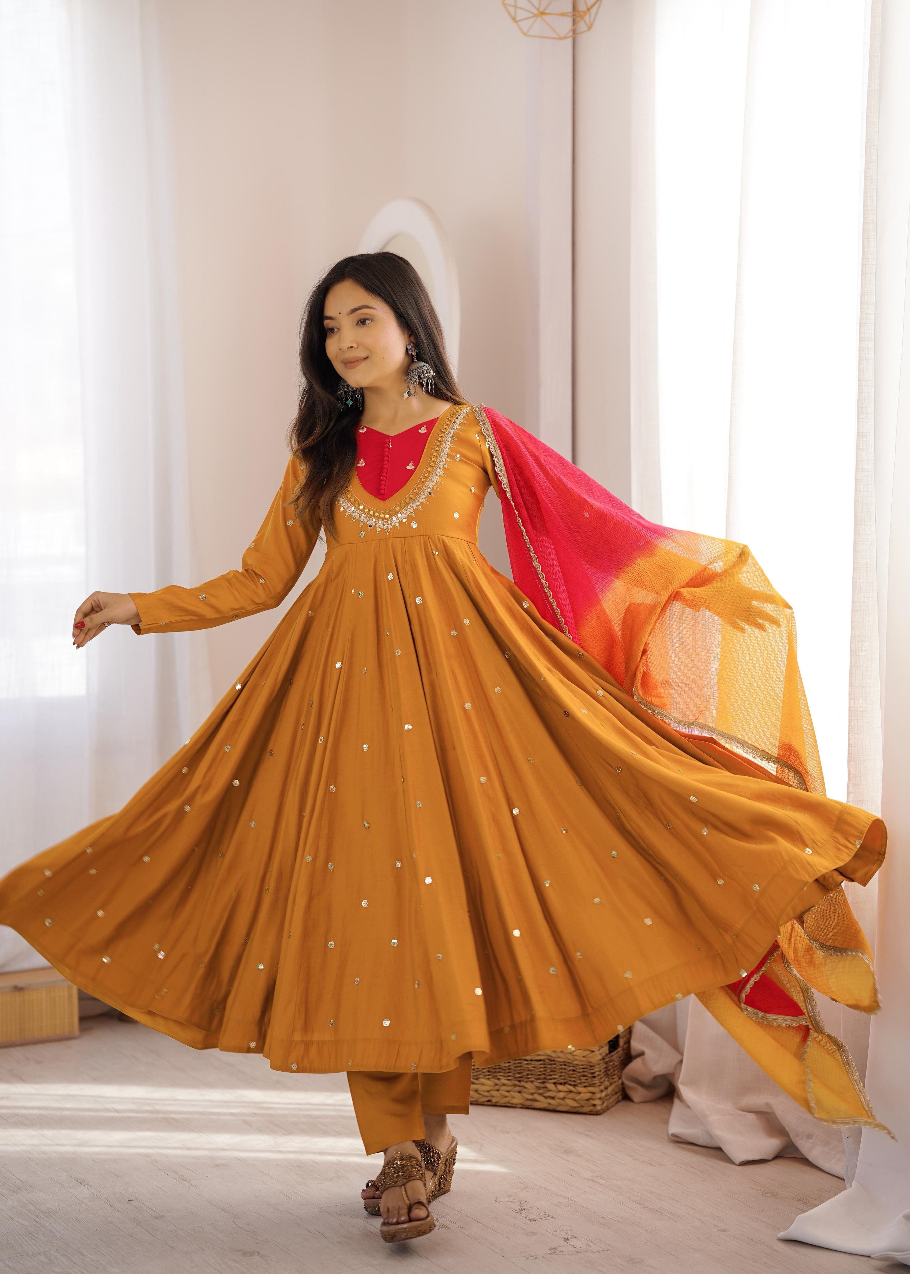 Women's Mustard Gold embroidered Roman Silk Anarkali suit displaying elegant flare with Kota Checks dupatta