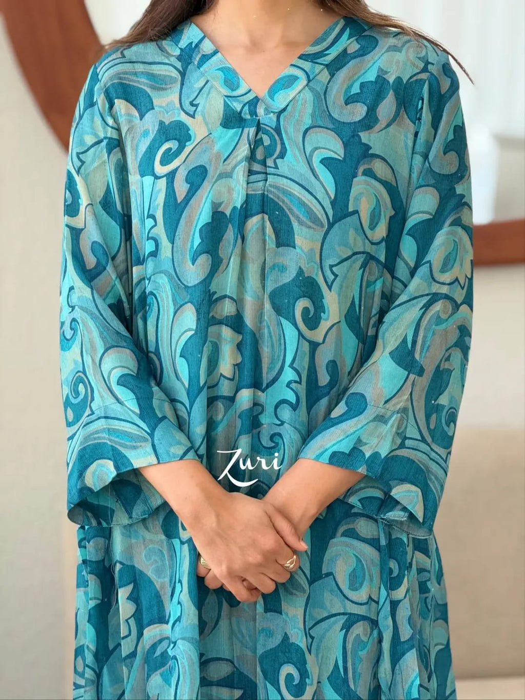 Close-up of Ocean Teal Softy Premium Chiffon Silk abstract print Anarkali gown showing V-neck and sleeves