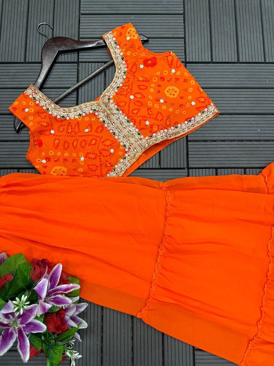 Orange shrug lehenga set featuring embroidered blouse and flared lehenga