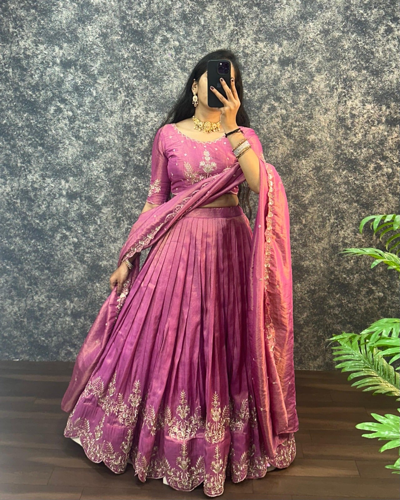 Model posing in Orchid Pink tissue cotton lehenga choli with embroidered border dupatta