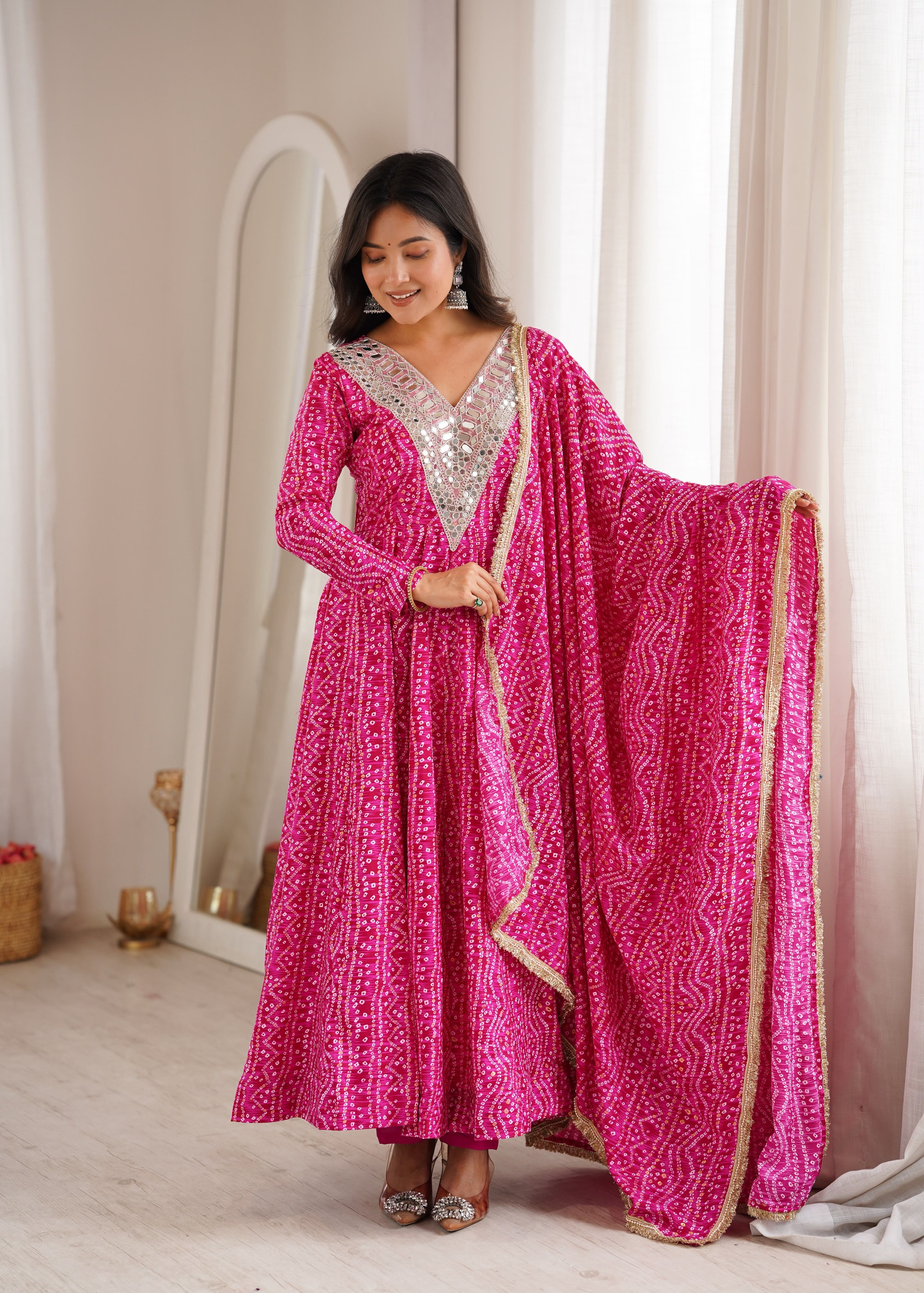 Woman wearing Rani Pink mirror embroidery rayon gown with dupatta