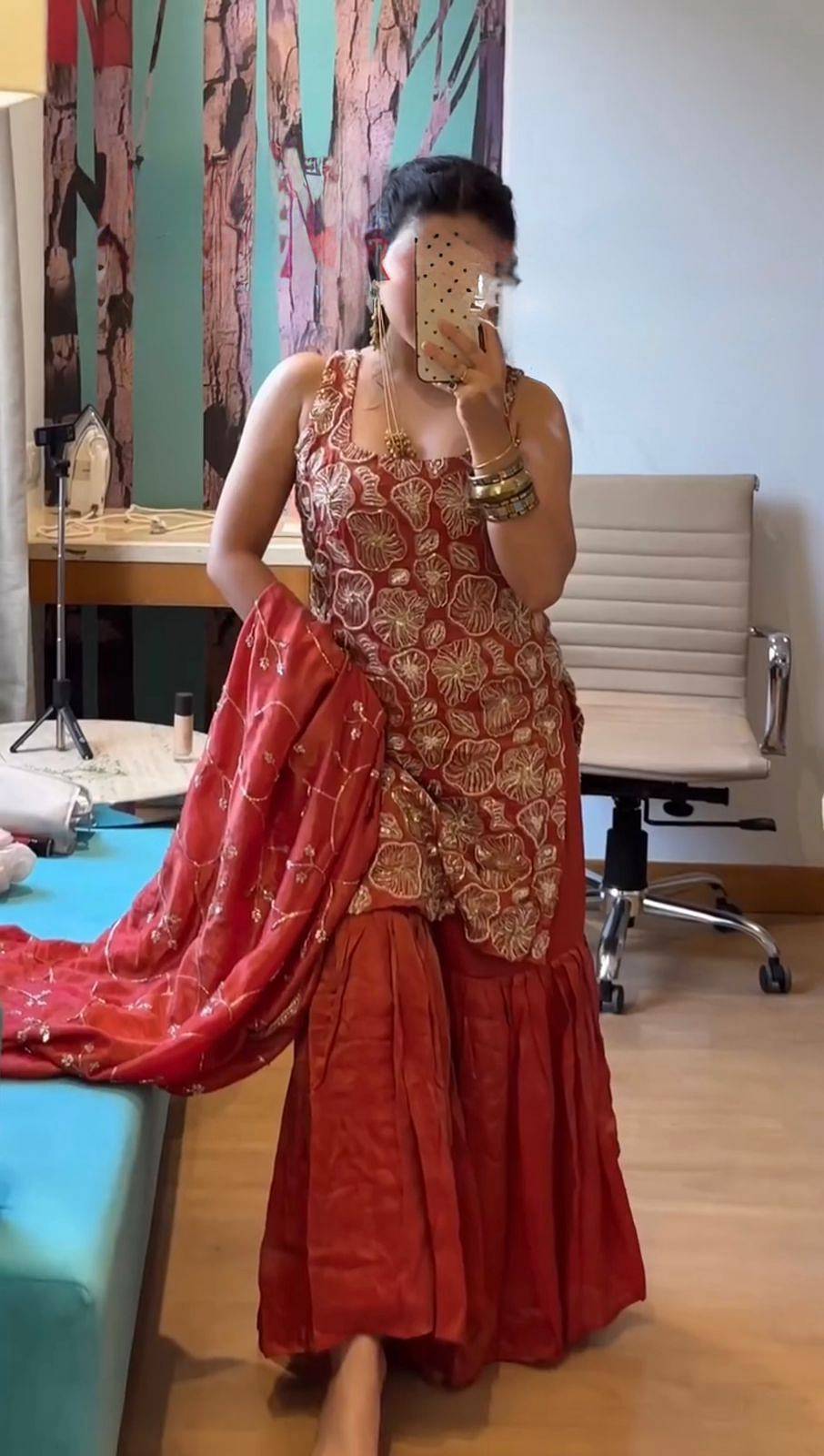 Side profile of red simmer silk sharara suit set with dupatta