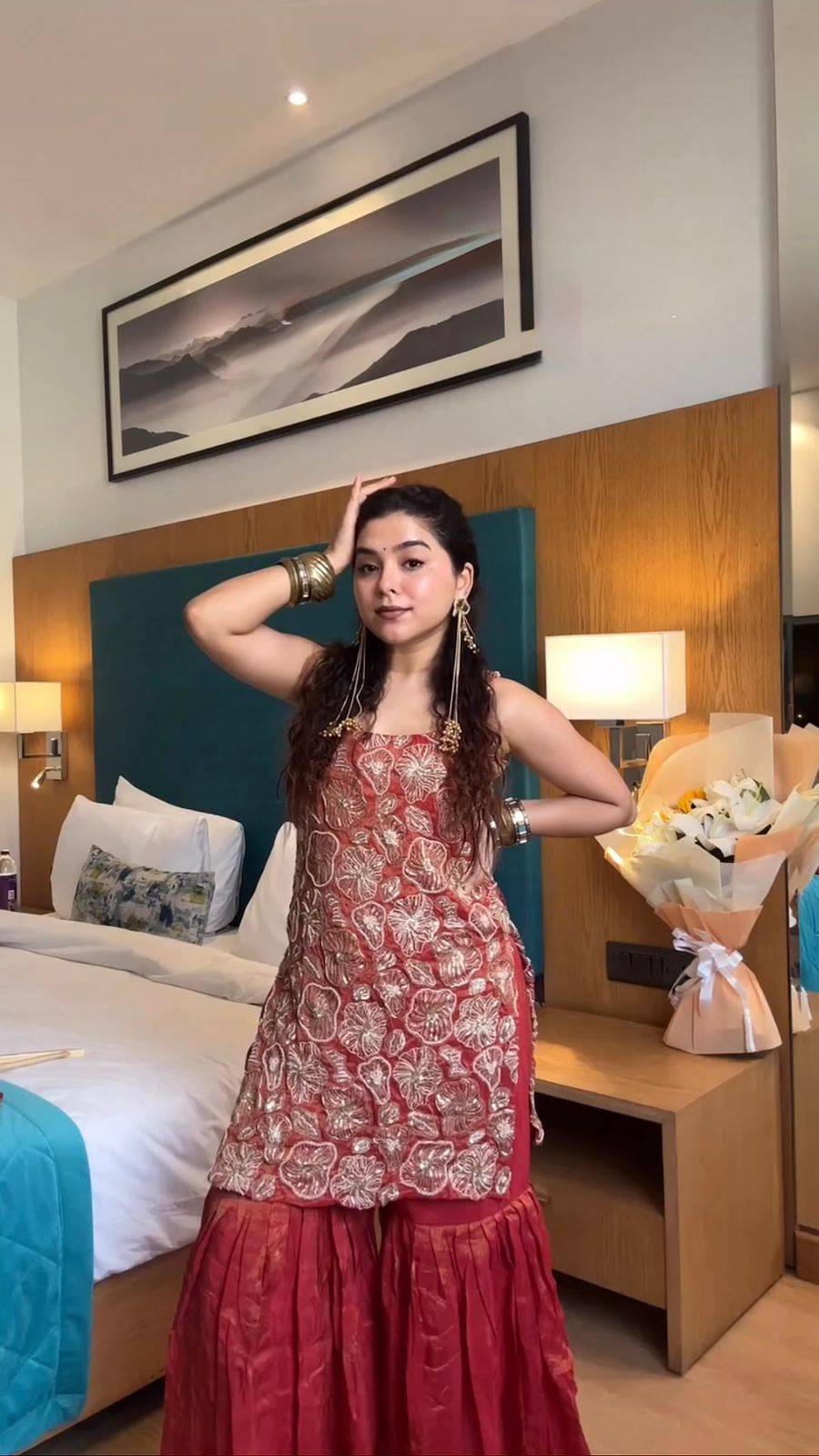 Woman wearing red embroidered simmer silk sharara suit set