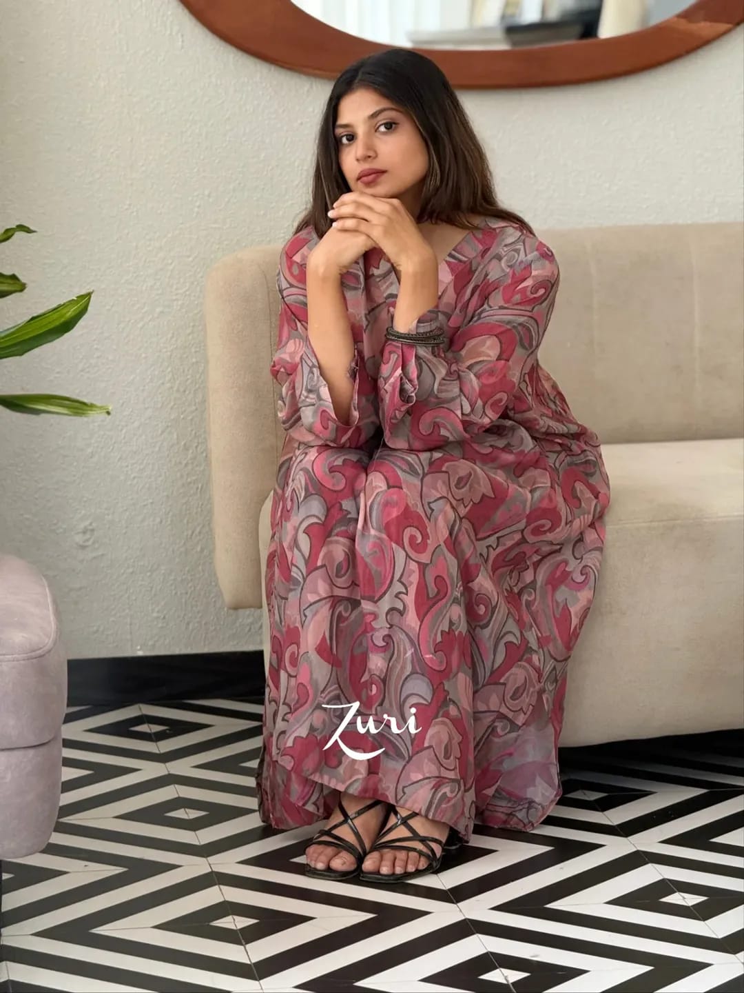 Seated model wearing Rose Pink Softy Premium Chiffon Silk abstract print Anarkali gown with pant