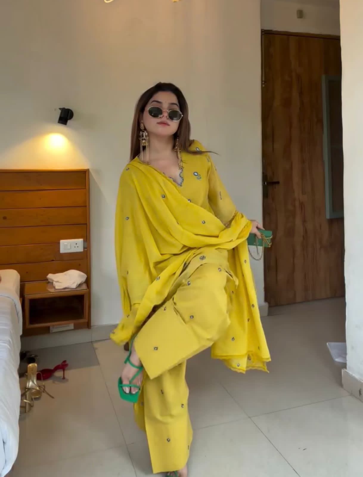 Side pose of woman wearing Sunshine Yellow embroidered Farshi Palazzo suit
