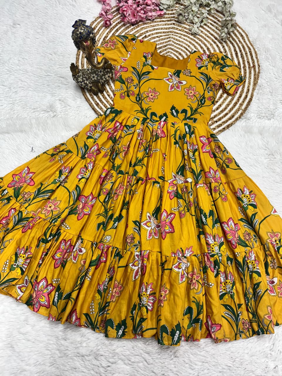 Flat lay of Sunshine Yellow floral printed Muslin Cotton 3 Layer dress showcasing flare