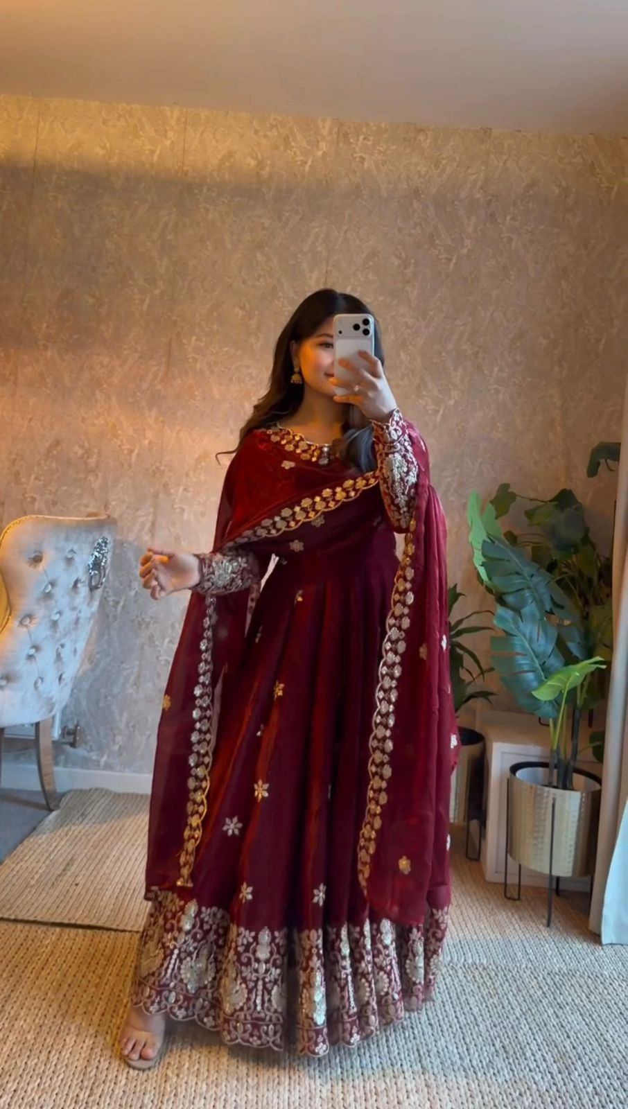 Woman wearing Wine Burgundy Fendy silk Anarkali suit with embroidered dupatta indoors